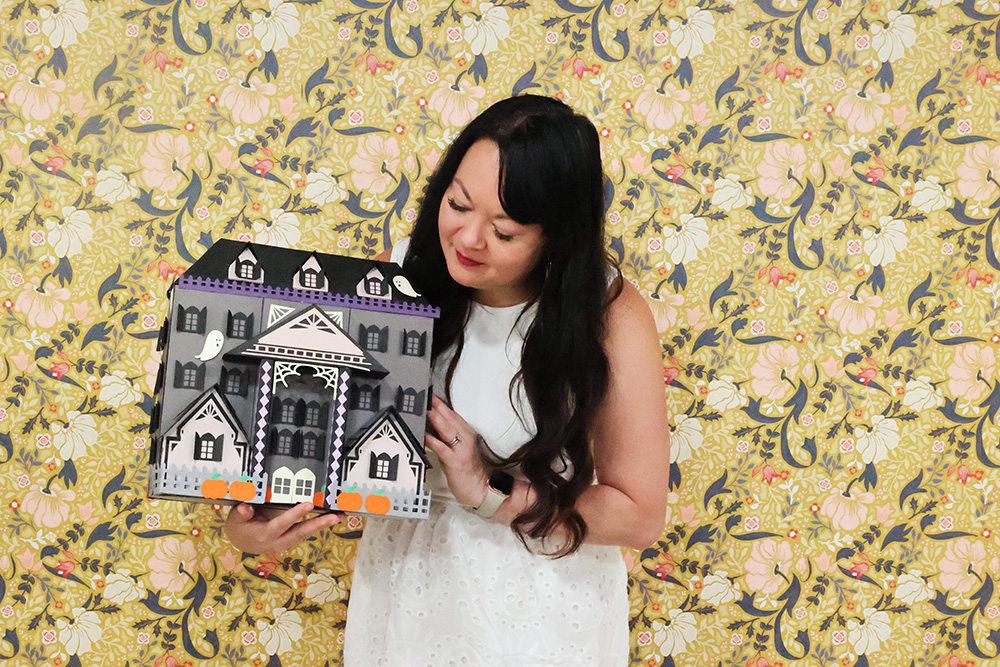 Carina Gardner with paper craft haunted house